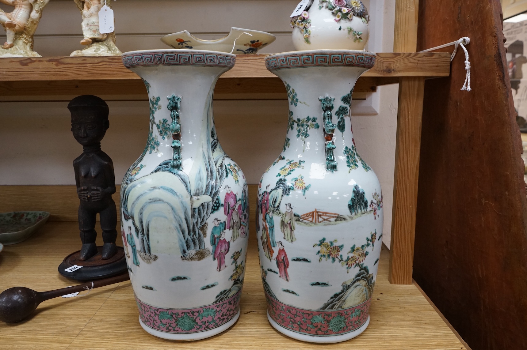A pair of large late 19th century Chinese famille rose ‘scholars’ vases, 45cm high